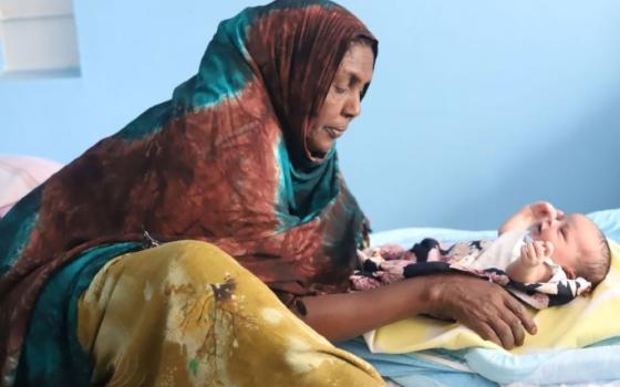 A woman tends to a newborn at the Kakuma Mission Hospital in Kakuma, a town in northwest Kenya. (GSR photo/Doreen Ajiambo)